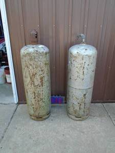 Qty of 2 100 lb propane tanks. 1 with valve, 1 without valve. AS shown.