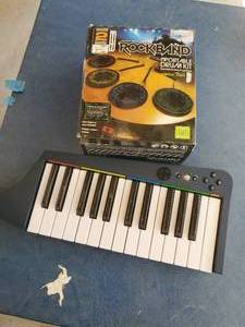 lot 115 image: Xbox360 Rockband 2 Portable Drum Set And Rockband 3 Wireless Keyboard