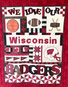 lot 8A image: University of Wisconsin Madison Quilted Wall Decor with Top Wooden Rod