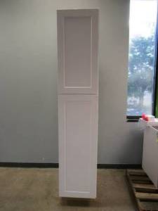 lot 480 image: HAMPTON BAY Shaker Satin White Stock Assembled Pantry Kitchen Cabinet (18 in. x 90 in. x 24 in.) (LITTLE DAMAGE ALONG THE BACK OF THE CABINET & NEXT TO DOOR, SEE PHOTOS)