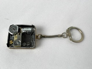 lot 16 image: Vintage Sankyo Silver and Gold Tone Music Box Keychain