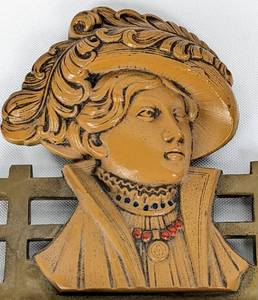 lot 90 image: Art Deco Bronze Metal Hanging Rack with Bakelite Woman Motif, Straw-Filled Tack Cushion