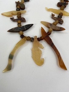lot 299 image: Vintage Native American Jewelry & Beadwork- Carved Critters Necklace, Replica Arrowhead on Leather Lanyard,  Three Pieces of Beaded Leather