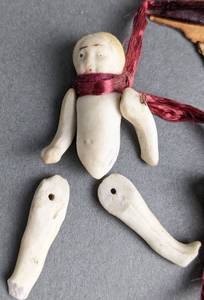 lot 338 image: Four Antique Miniature Jointed Bisque Dolls on a Ribbon - Frozen Charlottes  Moving Limbs
