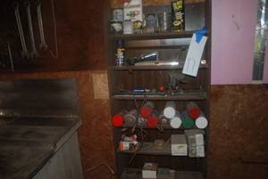 Contents of shelf, tools on wall, s...
