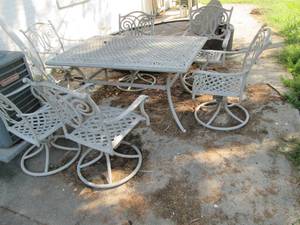 Metal patio table and 6 swiveling r...