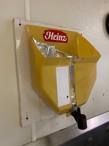 lot 19 image: KETCHUP BAG HOLDERDISPENSER