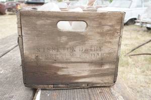 lot 79 image: Sisseton Dairy wood crate with  assorted milk bottles