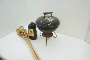 lot 116 image: small Weber grill and tiki torches