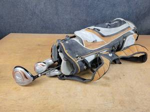 lot 1389 image: NICKLAUS Junior Left Handed Gold Clubs and Bag - NO SHIPPING