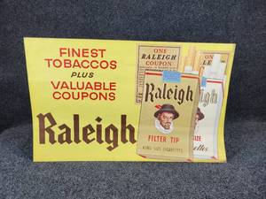 lot 1107 image: Vintage Raleigh Cigarettes Advertisement - Measures 26 W x 16 H