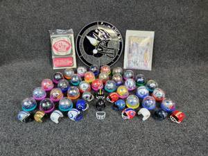 lot 1133 image: Lot of Football Goodies - Mini Helmets (45 Total), Vikings Stained Glass Window Hanger (10 Diameter), and Vintage Football Books