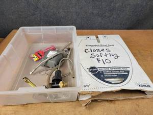 lot 1282 image: KOHLER Soft Closing Elongated Toilet Seat and Assorted Plumbing Supplies