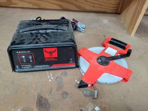 lot 281 image: Schumacher Farm & Ranch 12V Battery Charger and 100 Tape Measure