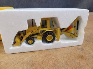 lot 1687 image: Caterpillar 428 Backhoe Loader w Hydraulic Hammer Diecast Model - 150 Scale - NZG Model 3781