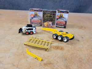 lot 2696 image: Bobcat 753 150 Scale Diecast Model, 3 Axle Dolly, Caterpillar and Case Trading Cards and More