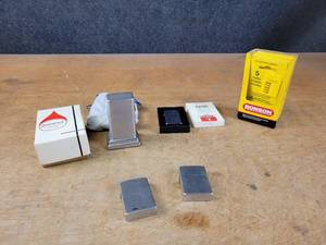 Vintage ZIPPO Barcroft Table Lighter in Original Box, ZIPPO Slim Lighter Model 1610 in Original Box, (2) Arirang Lighters and (12) Packages of Ronson 5-Pack Flints