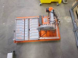 lot 887 image: RIDGID 9 Amp Corded 7 in. Wet Tile Saw with Stand (HEAVILY USED)