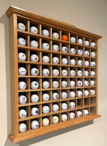 lot 49 image: Golf Ball Display Shelf with a Variety of Golf Balls