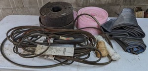 lot 48 image: Collection of Automotive Items Variety of Belts (Some New), Inner Tubes, Rolls of Rubber and Foam, and More