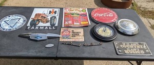 lot 94 image: Farmall Sign, Dodge Brothers Sign, Little Log House Advertisement, Chevy Hubcap and Emblem, 100th Anniversary Coca-Cola, Ford Torino Emblem