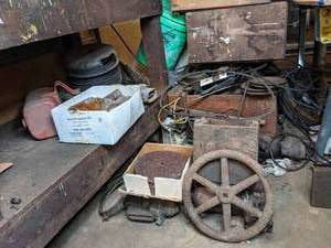 lot 207 image: Miscellaneous Garage Items - Hand Wheel, Discs, Fuel Tank, Glass Bottles, Wood Boxes, and More