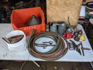 lot 213 image: Metal Oil Cans, Red Jacket Well Pump Water Diverter, Hoses, Miscellaneous Garage Items