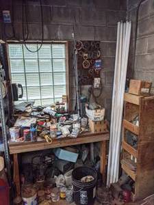 lot 203 image: Workshop Table, Wood Storage Shelf, and Miscellaneous Contents (Tools, Rotary Wall Phone, Fluorescent Lights, Gaskets, Scrap Metal Items, and more)