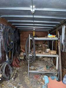 lot 438 image: Contents of Storage Unit Metal Shelving Unit, Hoses, and More