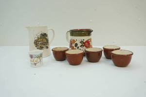 lot 130 image: water pitchers, toothpick holder, and pottery cup set