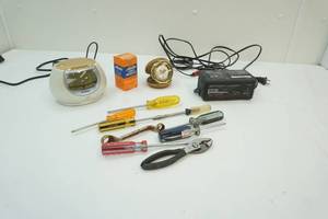 lot 153 image: Vintage Traveling alarm clock, alarm clock, battery charger, and group of tools