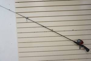 lot 230 image: Fishing rod with red EZ Cast reel