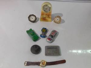 3 clocks, 2 belt buckles and 3 cars