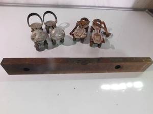 2 prs of vintage roller skates and a vintage level