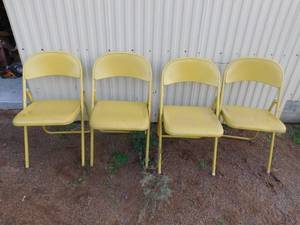 4 yellow metal fold up chairs