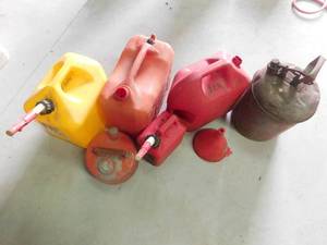 6 gas cans and a funnel