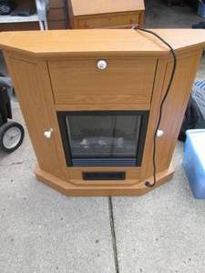 lot 26 image: Electric fireplace with storage cup...