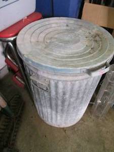 lot 96 image: Metal trash can filled with planter...