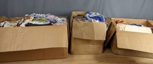 lot 144 image: A Collection of Scarves, Material, Various Sized Clothing and a Flag  Z