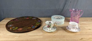 lot 276 image: Beautiful Painted Wood Lazy Susan Top, (2) Teacups and Saucers, Grasslands Road Mini Easter Appetizer Plates Set, and Pink Inverted Glass Thistle Pitcher X
