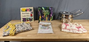 lot 264 image: All-Clad Copper Core 3 Quart Double Boiler Saucepan, Aprons, Sloth Dishtowel, Life in Balance by Donna Hay and Better Homes Garden Book X