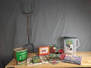 lot 256 image: Assortment of Scotts Whirl Hand Powered Spreader, Juegoal Window Hummingbird Feeder, Bag-in Dispenser for Bird Seed, The Roo Apron, Garden Magazines and More X