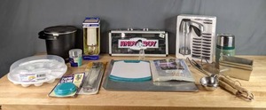 lot 353 image: A Collection of Kitchen Items, Fry Daddy, Formula Can Lids, Tablecloth, Cutting Board and More  W