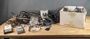 lot 393 image: Miscellaneous Assortment of Plantronics P10, Lithium Ion Phone Batteries, T-Mobile Sony Ericsson Flip Phone, Audiovox Portable CD Player, Phone Accessories and Much More W