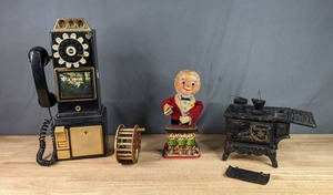 lot 390 image: Vintage Bartender Toy, Plastic Pay Phone and Black Cast-Iron Stove Figurine W
