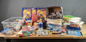 lot 385 image: A Collection of Birthday Party Decorations, Office Supplies, Wrist Bands, Buttons and More  W