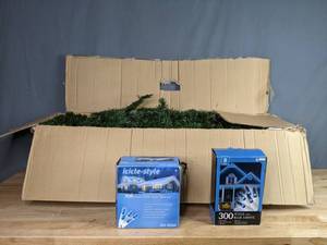 lot 378 image: 7 Foot Fraser Fir Christmas Tree with 2 Boxes of Blue Icicle Style Lights   W
