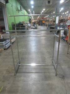 lot 545 image: Rolling Clothes Rack With Adjustable Bar Height and Wire Basket.  Approximate Dimensions (When Bars are lowered) 49 x 22 x 48 Tall. Used in Retail Store.  SOLD AS PICTURED