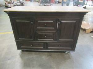 lot 559 image: Makeshift Rolling Workbench from Vanity Filled with Warehouse Items. Approximate Dimensions 49 x 24 x 35 Tall. Used in Warehouse.  SOLD AS PICTURED