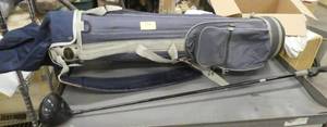 lot 111 image: Golf bag with a Swing Trainer club, weighted to help you improve your swing